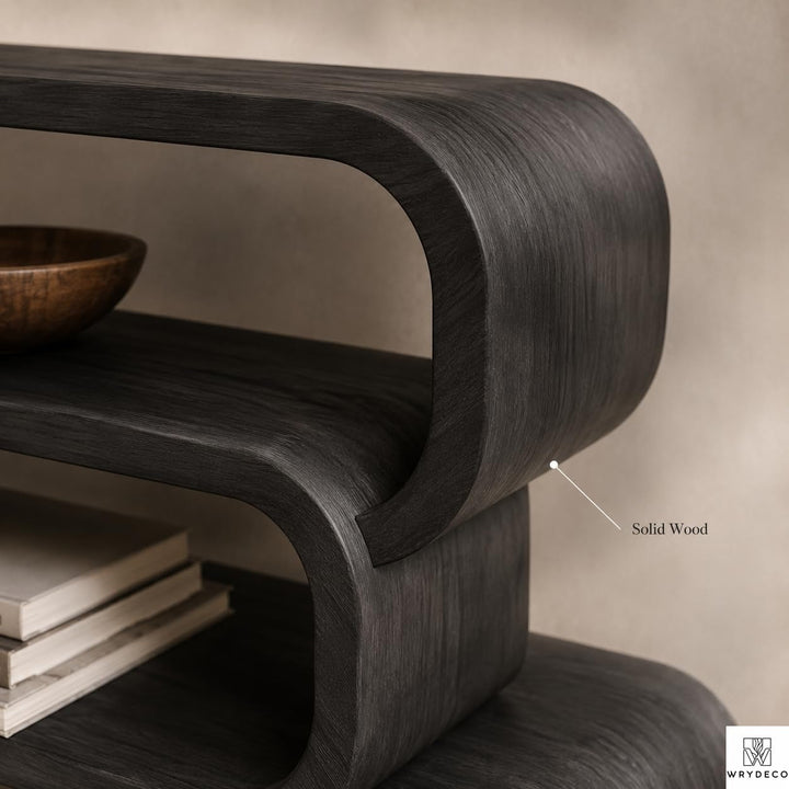 Modern Curved Wood Bookcase for Living Room Display - View 3. Sculptural Curved Storage A statement solid wood bookshelf that combines open storage with a flowing curved silhouette, bringing warmth, artistic character, and practical display space into modern interiors. 01 Sculptural Curved Design The flowing curved silhouette blends functional shelving with an artistic form, creating a modern focal point while providing open display space for books, plants, décor, and everyday objects. 02 Solid Wood Craf...