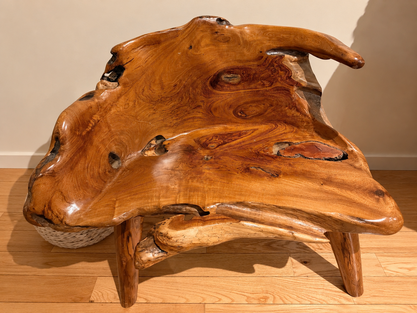 A handcrafted natural wood table and shelving in a warm, sunlit interior
