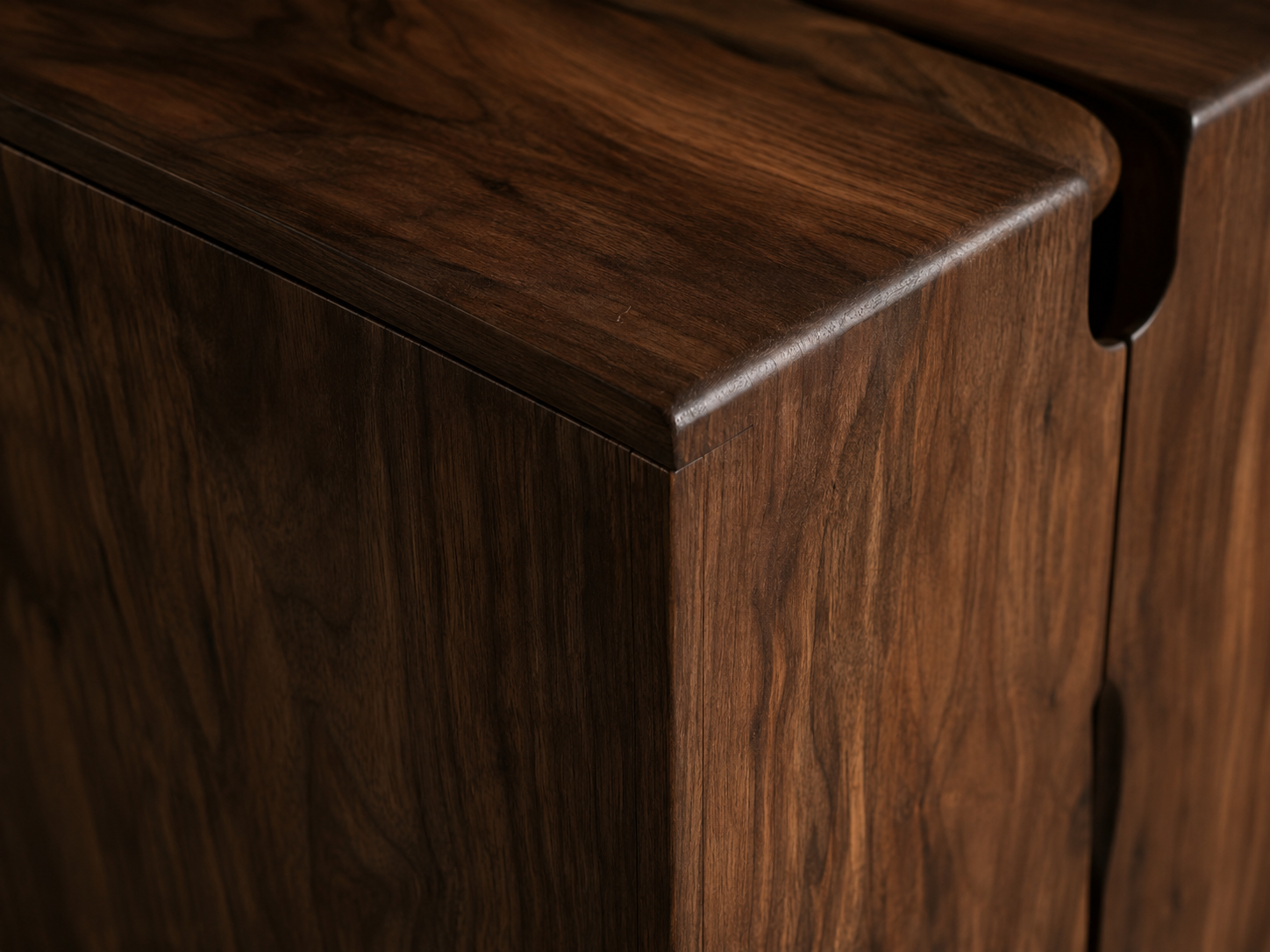 Matte walnut cabinet corner with soft grain detail