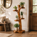 Rustic wooden tree-shaped planter holder styled with potted plants in living room corner